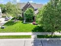 An aerial view of the beautiful brick home and landscaped front yard at 10155 Landis Blvd, Fortville, IN 46040