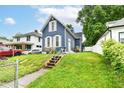 Exterior view of a two story home featuring a well-kept lawn and proximity to neighboring homes at 1115 N Keystone Ave, Indianapolis, IN 46201