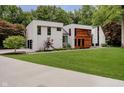 Modern two-story home featuring a beautifully landscaped lawn and mixed material exterior at 11911 Eden Glen Dr, Carmel, IN 46033
