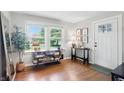 Sunlit entryway boasting hardwood floors, a console table and shelving under a bright picture window at 1245 Kessler Blvd E Dr, Indianapolis, IN 46220