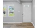 Bright entryway featuring wood flooring, neutral walls, and a white door and trim at 1328 Toner Dr, Anderson, IN 46012