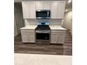 Well-equipped kitchen with stainless steel oven, microwave, and modern countertops at 13460 Dewpoint Ln, Fishers, IN 46037