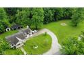 Aerial view of this beautiful home showing the winding driveway and verdant yard at 1409 S Northview Dr, Martinsville, IN 46151