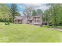 View of a unique home design and large lawn with attached garage at 1409 S Northview Dr, Martinsville, IN 46151