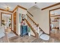Warm and inviting foyer featuring hardwood floors, staircase, and decorative accents creating a charming entry at 14809 Senator Way, Carmel, IN 46032