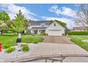 Inviting two-story home showcasing a well-maintained lawn and a spacious driveway leading to an attached garage at 14809 Senator Way, Carmel, IN 46032