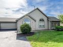 Residential home featuring stone accents, siding, a well-manicured lawn, and an attached garage with driveway at 16657 Brownstone Ct, Westfield, IN 46074