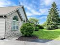 Lovely home with stone accents, mature trees, and a well-maintained lawn and landscaping at 16657 Brownstone Ct, Westfield, IN 46074