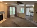 Inviting living room featuring a cozy fireplace, large windows, and seamless flow into an adjacent kitchen area at 1716 W Witt Ave, Lebanon, IN 46052