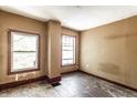 Bedroom featuring natural light from two windows and original hardwood floors ready to be refinished at 2114 Sugar Grove Ave, Indianapolis, IN 46202