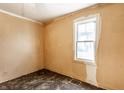 Bedroom with natural light from a window, hardwood floors, and freshly painted walls at 2114 Sugar Grove Ave, Indianapolis, IN 46202