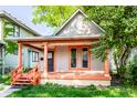 Charming home featuring a covered porch with orange columns and freshly painted trim accents at 2114 Sugar Grove Ave, Indianapolis, IN 46202