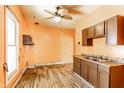 The kitchen features wood cabinets, a stainless steel sink, and a window for natural light at 2114 Sugar Grove Ave, Indianapolis, IN 46202