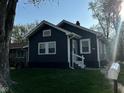 Charming single-story home with dark siding and a well-maintained lawn at 2115 N Leland Ave, Indianapolis, IN 46218