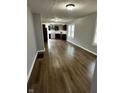 Spacious living room with wood floors flows seamlessly into the modern kitchen at 2115 N Leland Ave, Indianapolis, IN 46218
