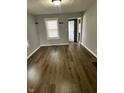 Bright living room featuring wood floors and fresh paint, perfect for relaxation at 2115 N Leland Ave, Indianapolis, IN 46218