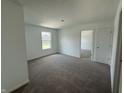 Bright bedroom featuring neutral carpet and a view of the outdoors through a large window at 24391 Stout St, Sheridan, IN 46069