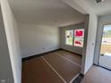 Bright living room with new flooring and large windows, ready for your personal touch at 24391 Stout St, Sheridan, IN 46069