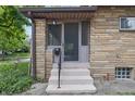 Inviting home entrance featuring brick facade and concrete steps with a black railing at 309 Poplar Rd, Indianapolis, IN 46219