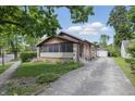 Charming single-story home with a brick facade, detached garage, and well-manicured lawn at 309 Poplar Rd, Indianapolis, IN 46219