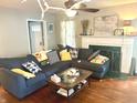 Bright living room featuring hardwood floors, fireplace, and comfortable seating area at 310 S Butler Ave, Indianapolis, IN 46219