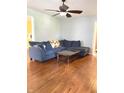 Comfortable living room with hardwood floors, large couch, and glass coffee table at 310 S Butler Ave, Indianapolis, IN 46219