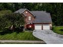 Two-story brick home with an attached garage and a landscaped yard at 310 Wellington Overlook, Noblesville, IN 46060