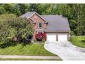 Beautiful brick two-story home with a well-maintained yard and a two-car garage at 310 Wellington Overlook, Noblesville, IN 46060