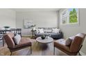 Inviting living room showcasing stylish furniture, a gray sofa, and lots of natural light at 316 S Roena St, Indianapolis, IN 46241