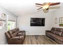 Spacious living area featuring wood-look floors, a large TV, and comfortable seating with cupholders at 3608 Valley Lake Dr, Indianapolis, IN 46227