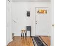 Bright foyer with hardwood floors, white walls, staircase and door with a mail organizer at 3937 Candle Berry Dr, Indianapolis, IN 46235