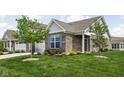 Beautiful brick home with a two-car garage, trimmed lawn and fresh landscaping at 4034 Cairo Way, Avon, IN 46123