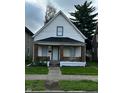 Charming two-story home with white siding, inviting front porch, and well-maintained lawn at 41 S Warman Ave, Indianapolis, IN 46222