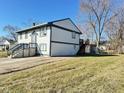 The side yard shows a two story home with neutral siding, dark trim, and a well manicured lawn at 4144 Richelieu Rd, Indianapolis, IN 46226