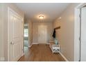 Inviting foyer featuring hardwood floors, neutral paint, and a convenient coat rack at 4309 Viva Ln, Indianapolis, IN 46239