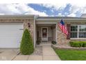 Welcoming front porch features an American flag, seasonal décor, and a charming brick exterior at 4309 Viva Ln, Indianapolis, IN 46239