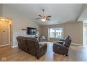 Comfortable living room with vaulted ceiling, ceiling fan, and leather furniture set at 4309 Viva Ln, Indianapolis, IN 46239