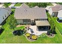 An aerial view showcases a backyard featuring a patio, gazebo, mature trees and a landscaped yard at 5047 Skipping Stone Dr, Indianapolis, IN 46237