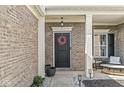 Inviting front door with wreath, complemented by a cozy seating area on the porch at 5622 Hare Dr, Noblesville, IN 46062