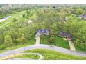 Beautiful aerial view of a brick home nestled in a lush, green neighborhood at 5948 Ridge Hill Way, Avon, IN 46123