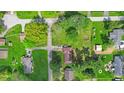 Aerial view of the property showcases lush greenery, neighboring homes, and the surrounding landscape at 6191 Geneva St, Stilesville, IN 46180