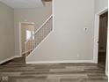 Open-concept living room with stairwell and durable flooring at 623 Orange St, Indianapolis, IN 46203