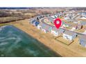 Aerial view of the home's location in a neighborhood near a pond, marked by a red pin for easy identification at 6903 Aster Dr, Pendleton, IN 46064