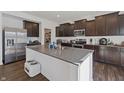 Modern kitchen with dark cabinets, stainless steel appliances, granite countertops and a large center island with a sink at 6903 Aster Dr, Pendleton, IN 46064