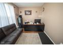 Cozy home office features a comfortable sofa, a desk, a filing cabinet, and hardwood flooring at 6913 Thousand Oaks Ln, Indianapolis, IN 46214