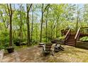 Inviting backyard brick patio with a seating area and scenic views of a lush, wooded landscape at 7189 Creekwood Estates, Brownsburg, IN 46112
