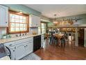 Bright kitchen featuring white cabinets, stainless steel appliances, and an eat-in area with backyard views at 7189 Creekwood Estates, Brownsburg, IN 46112