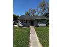 Charming single-story home featuring gray siding, a dark roof, and well-maintained front lawn at 7334 Westchester Dr, Indianapolis, IN 46226