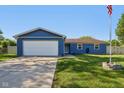Exterior shot of a home featuring a neatly kept lawn and a driveway leading to an attached garage at 7645 Madden Dr, Fishers, IN 46038