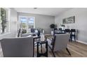 Bright living room with modern decor, hardwood floors, large windows, and neutral-colored furniture, creating a cozy atmosphere at 807 Vasbinder Dr, Chesterfield, IN 46017